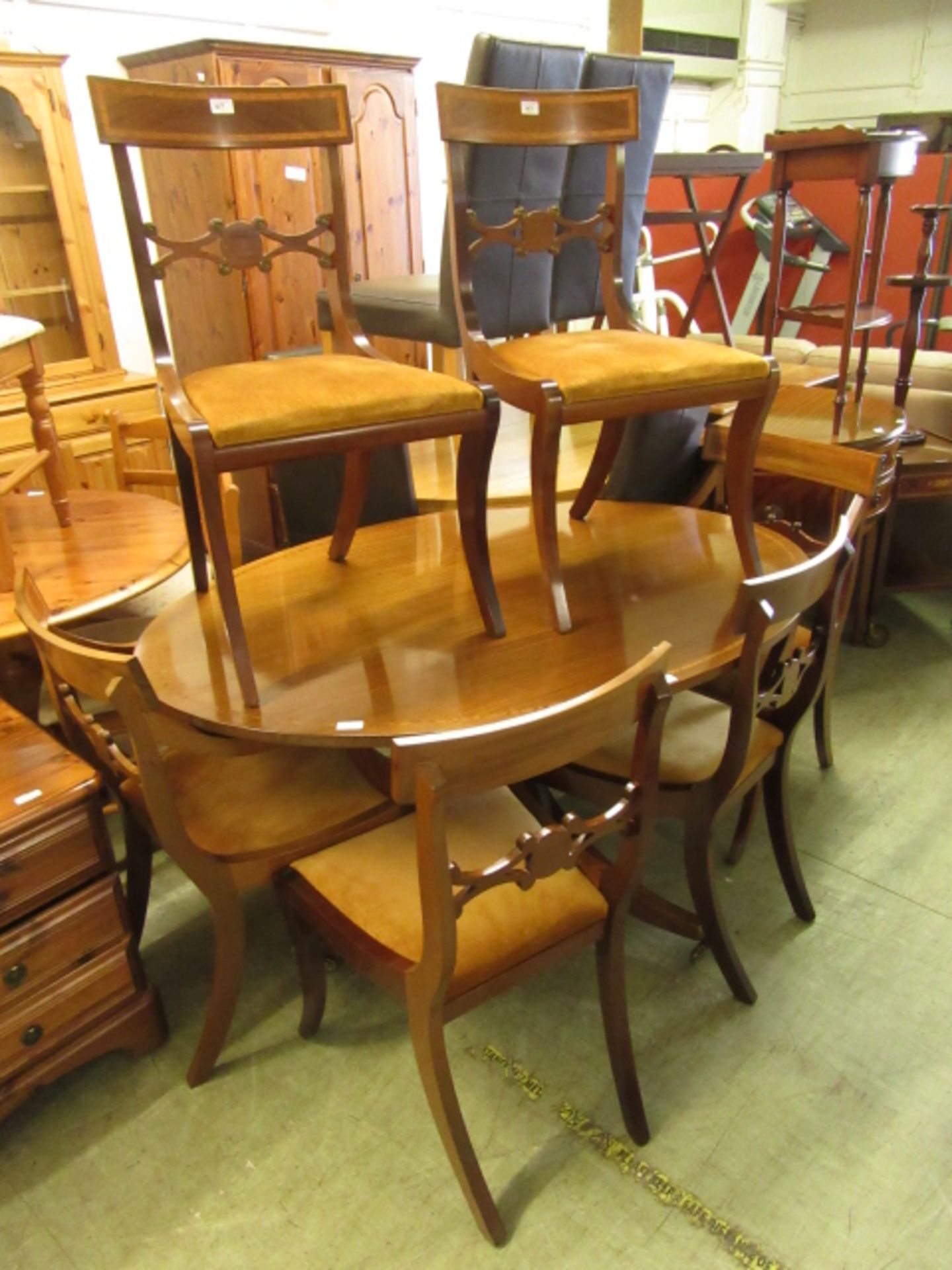 A reproduction mahogany single pedestal dining table along with a set of six (4+2) dining chairs