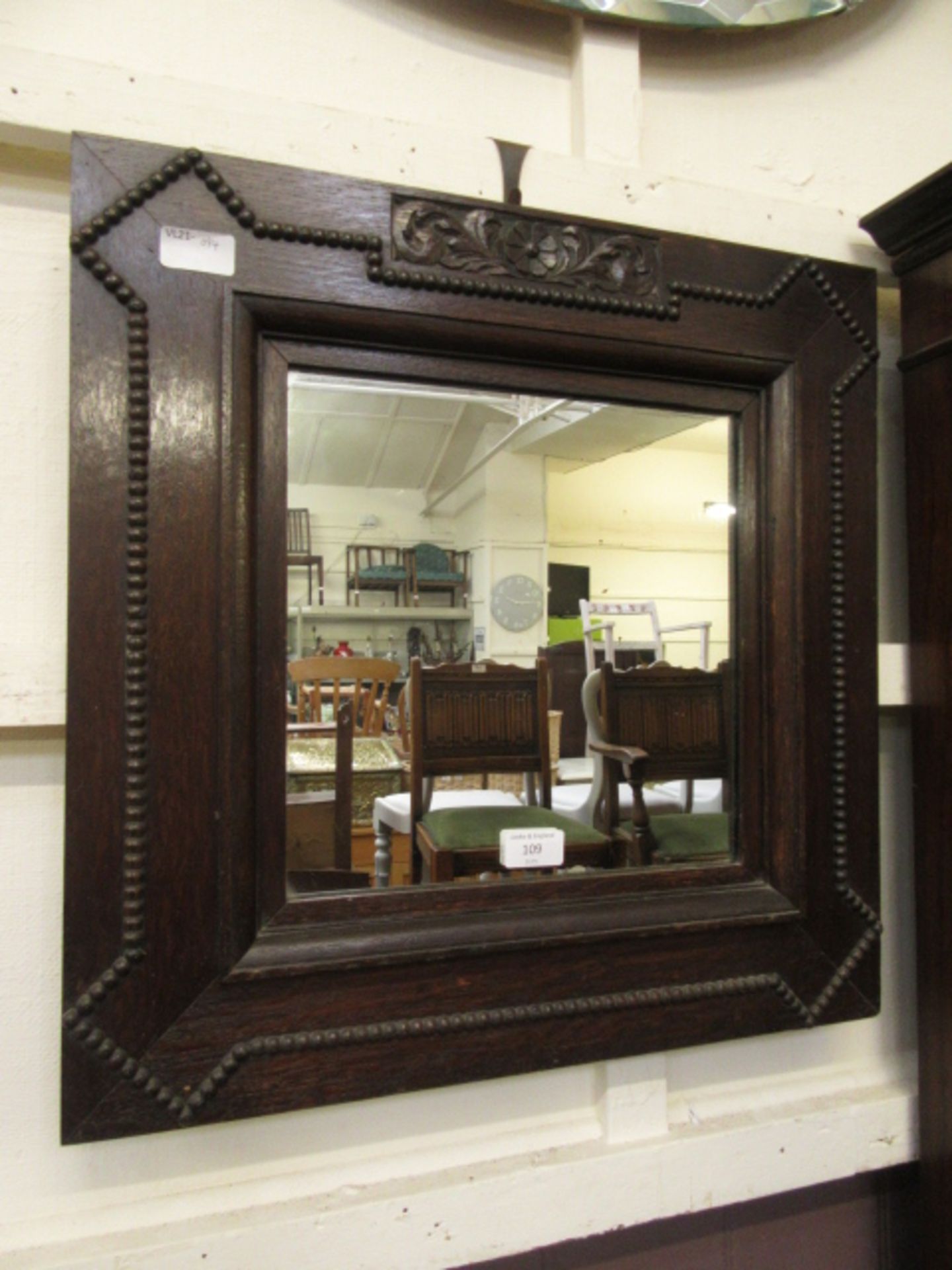 An early 20th century oak framed wall mirror