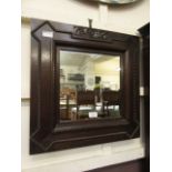An early 20th century oak framed wall mirror