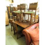 An early 20th century oak refectory dining table together with a set of four standard one carver