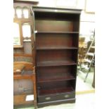 A modern mahogany open bookcase with drawer to base