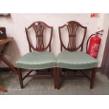 A pair of reproduction Hepplewhite style shield back single chairs upholstered with green diamond