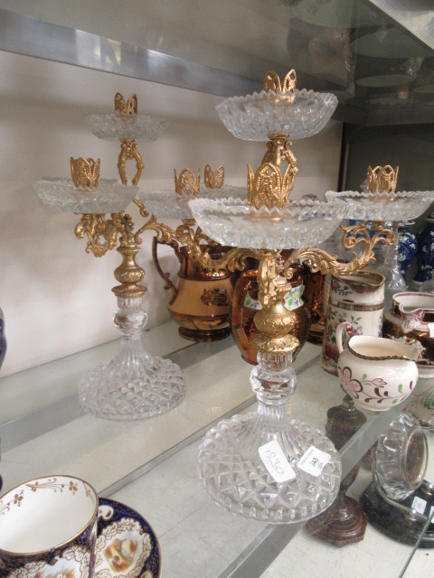 A pair of gilt metal and pressed glass candelabra