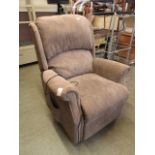 An electric reclining chair upholstered in a biscuit coloured fabric