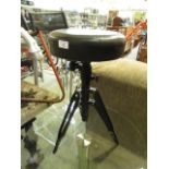 A circular seated music stool