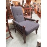 An Edwardian walnut adjustable reclining armchair upholstered in a grey fabric