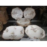 A selection of Limoges plates and bowls with a floral gilt decoration