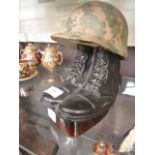 A desk top decanter in the style of military boots and helmet