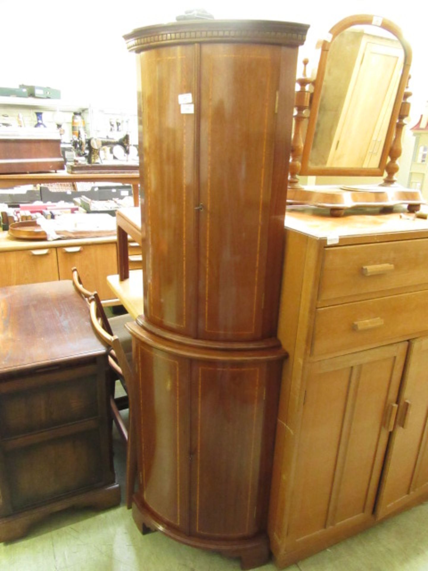 A reproduction full height mahogany bow-fronted cabinet