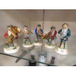 A collection of five continental ceramic comical musicians in the form of toads