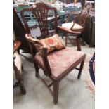 A Georgian style mahogany open armchair upholstered in a needlework fabric