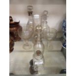 A collection of seven early 20th century and earlier glassware to include decanters,