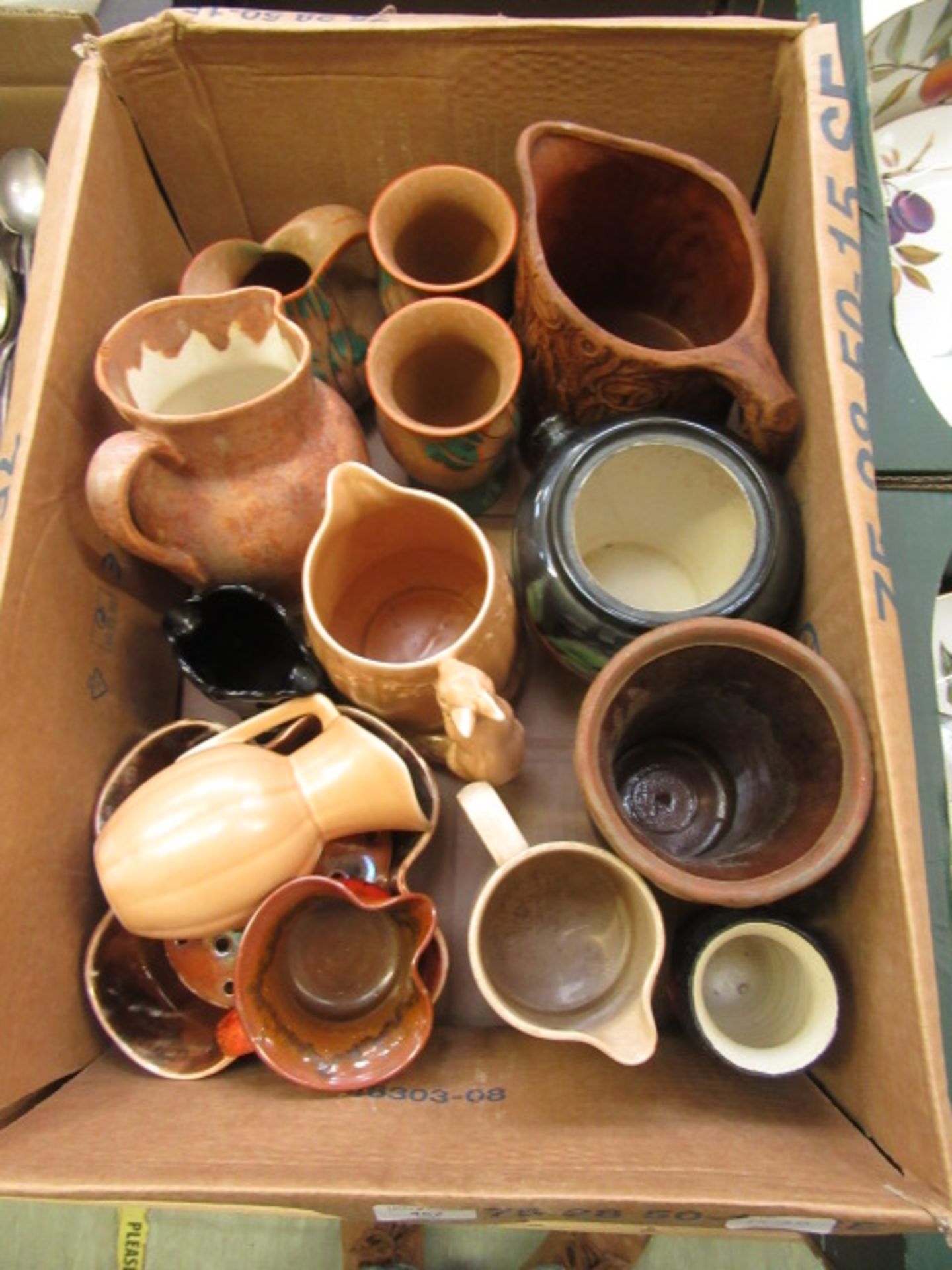 A box containing an assortment of mid-20th century pouring jugs, vases etc.