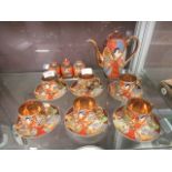A Japanese tea set comprising of a tea pot, cups, saucers etc.