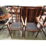 A pair of early twentieth century oak framed open arm chairs