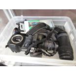 A box containing an assortment of cameras and lenses
