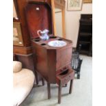 A Georgian mahogany wash stand/commode, a lift up top over bowl wells, cupboard door,