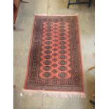 An Afghan rug decorated on a peach ground