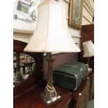 A brass effect table lamp with Corinthian column