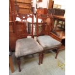 A pair of Edwardian walnut side chairs having over stuffed seats