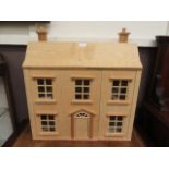 A modern plywood dolls house with a selection of furniture