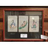 A framed and glazed display of three Japanese paintings of ladies on rice paper