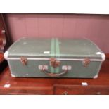 An early 20th century green tin suitcase