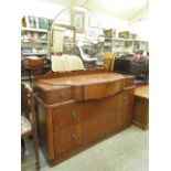 An Art Deco walnut dressing table having three small short drawers over two long