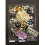 An assortment of costume jewellery to include faux pearls, brooches etc.