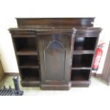 A Victorian oak Gothic revival bookcase with open storage flanking cupboard door