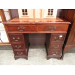 A reproduction mahogany twin pedestal desk with tooled brown leather insert to top