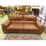 A brown leather three seater settee