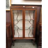 An early 20th century oak display cabinet on cabriole legs