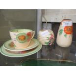 A collection of Clarice Cliff ceramic ware to include sugar sifter, sugar bowl, cup,