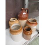 Five assorted stoneware flagons and storage jars