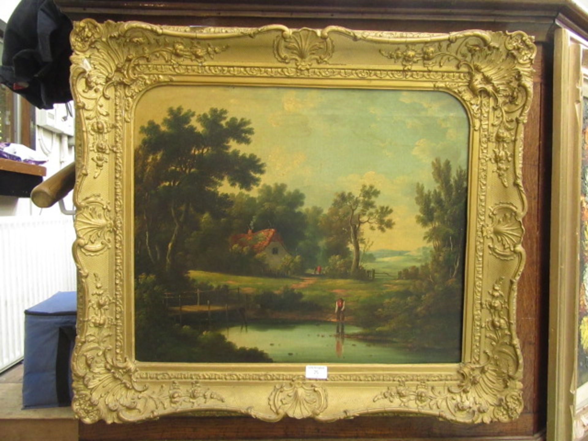 A gilt framed oil on canvas of cottage by lake scene