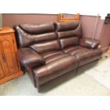 A modern brown leather electric reclining two seater sofa