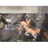 A selection of Babycham glasses together with three Babycham fawns