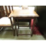 An early 20th century oak and beech scallop topped occasional table