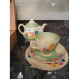 A Clarice Cliff trio tea set comprising of cup,