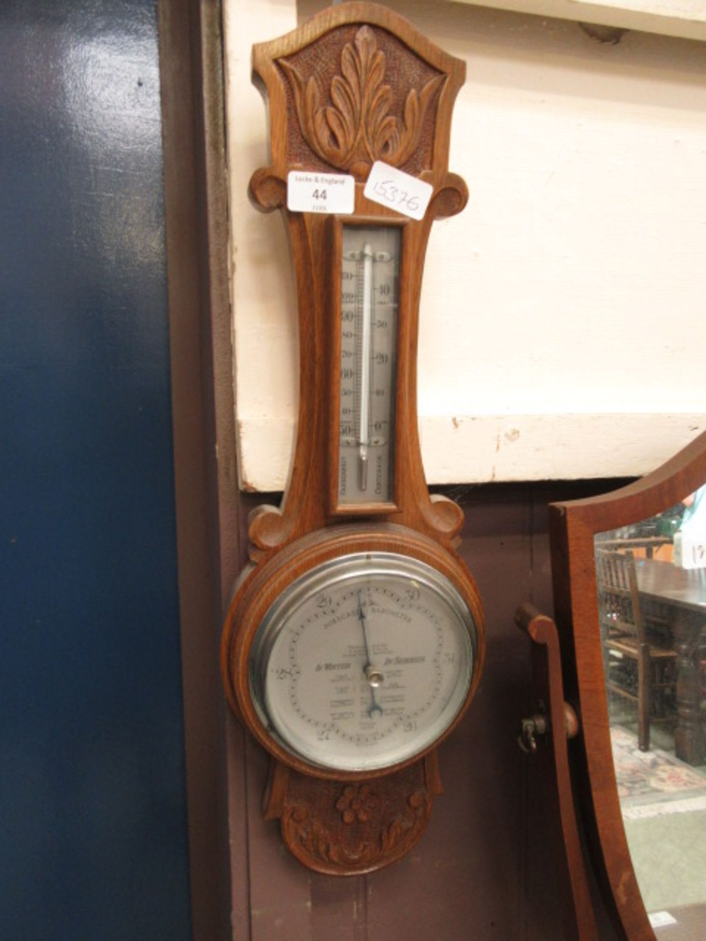 An early 20th century carved oak banjo barometer