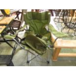 A green folding camping chair