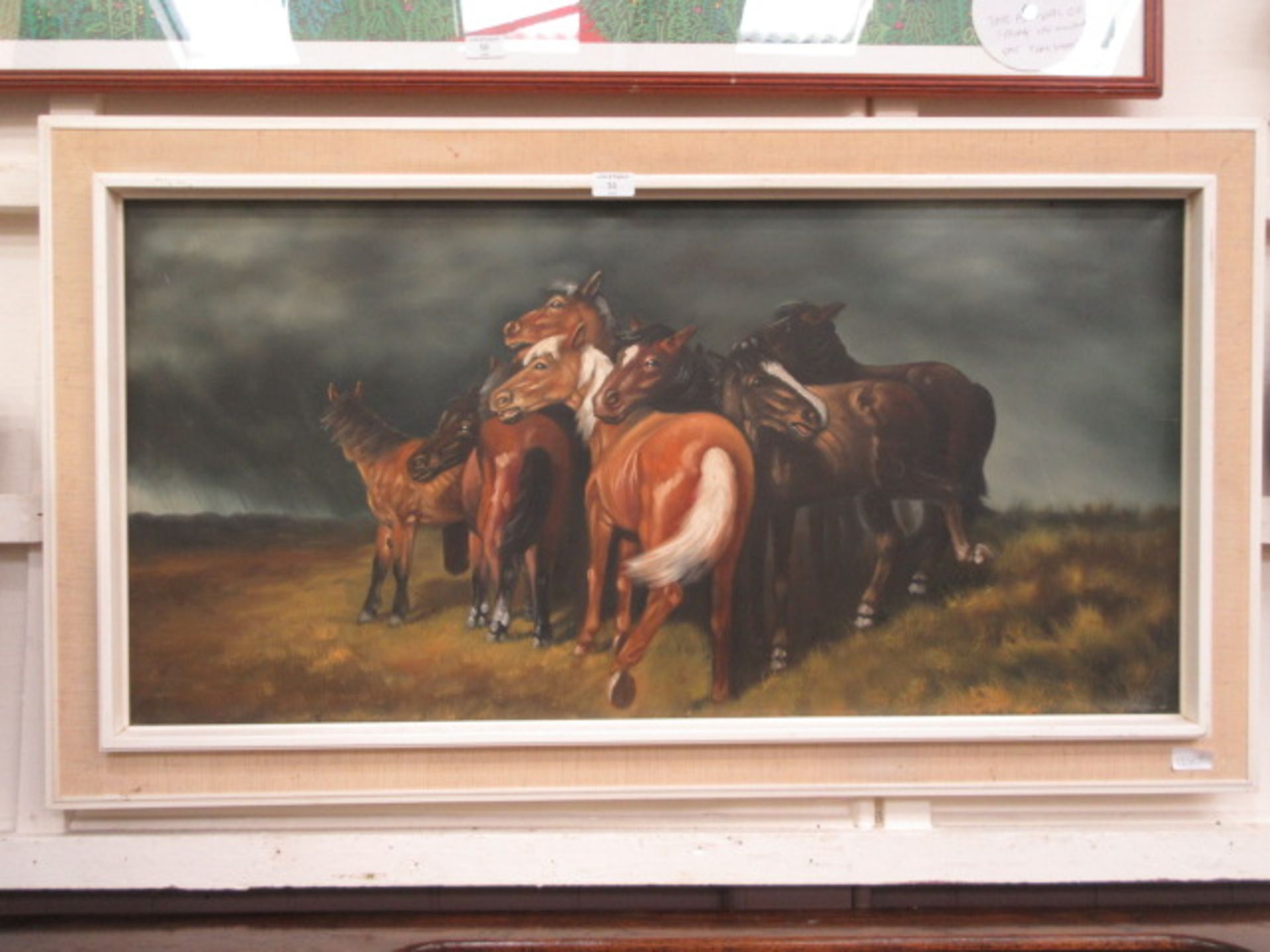 A framed oil on canvas of cuddling horses