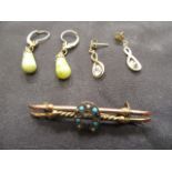 A bag containing an assortment of yellow metal earrings, brooch etc. approx. weight 5.