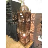 An eastern style pierced metal lamp