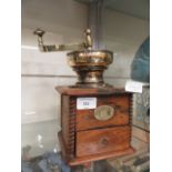 An early 20th century brass and wooden coffee grinder