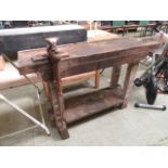 A wooden work bench with vice