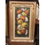 A framed oil on canvas of chrysanthemums signed bottom right