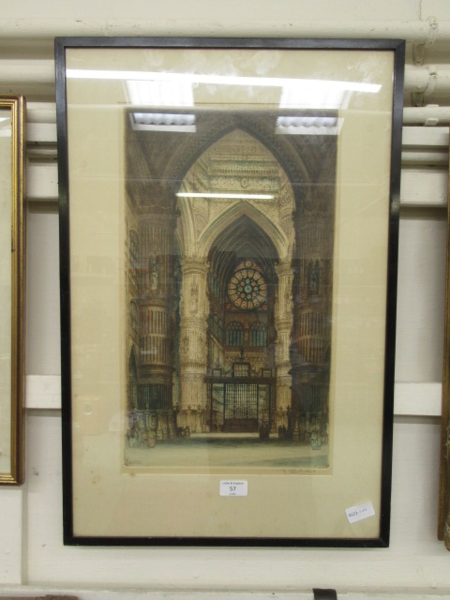 A framed and glazed hand coloured engraving of cathedral interior signed bottom right