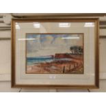 A framed and glazed watercolour of beach scene signed Dyer